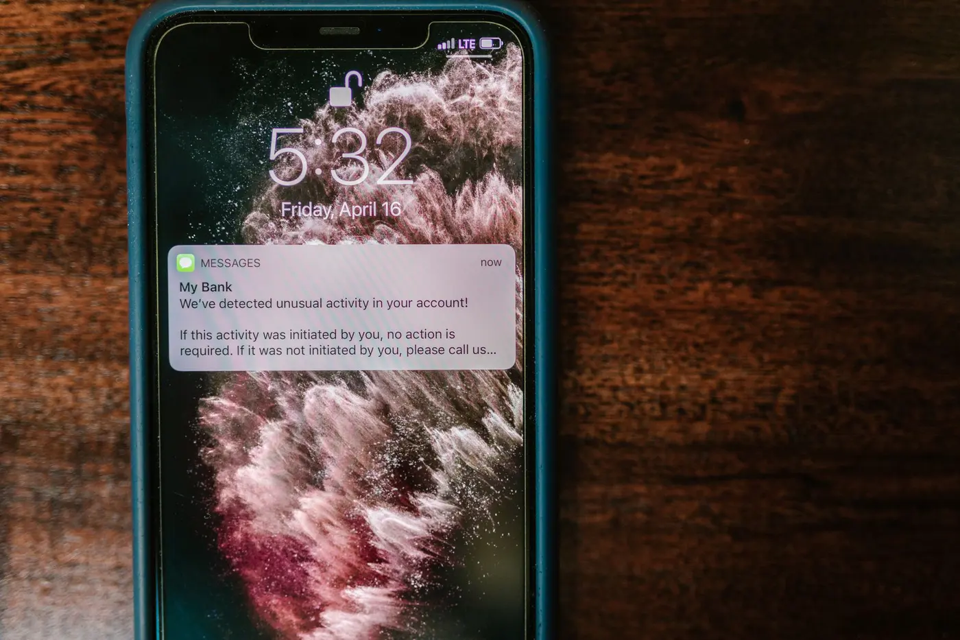 Smartphone glowing with notification in dark room — after-hours patient call